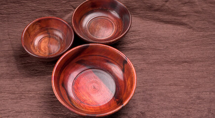 Empty wooden bowl and wooden spoon isolated with copy space.