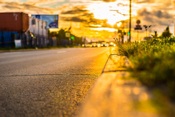Sunset in the city. Headlights of the approaching cars, view from the border level