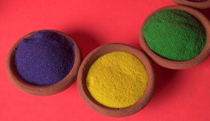 Diwali Festival showing Colourful rangoli in bowls,clay lamp or diya on background