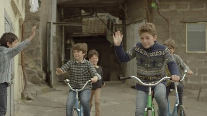 4K. Happy kids, friends riding bikes, bicycles . Vintage times. Memories. Shot on RED EPIC DRAGON Cinema Camera in slow motion. - Powered by Adobe