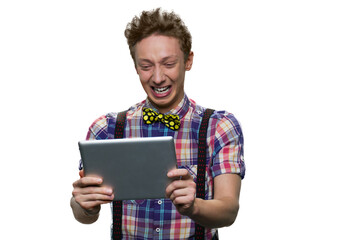 Stressed crying teenage boy is looking at tablet pc screen.