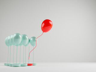 Red balloon floating out from blue balloons that are tied on white background , Performance...