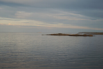 Sunset over the sea and calm water. Photo taken in the Swedish archipelago on a summer evening.