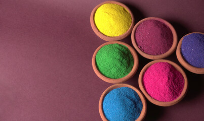 Diwali Festival showing Colourful rangoli in bowls,clay lamp or diya on background