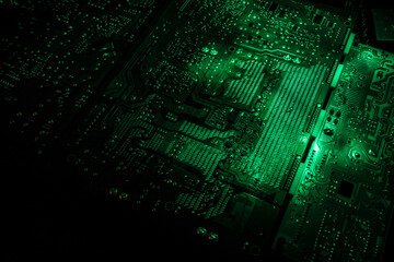 Stylized photo of an electronic microcircuit. Microcircuit, contacts, electronics, motherboard. Black background. Macro photography of electronic devices.