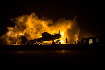 German Junker (Ju-88) night bomber at night. Artwork decoration with scale model of jet-propelled plane in possession. Toned foggy background with light. War scene.