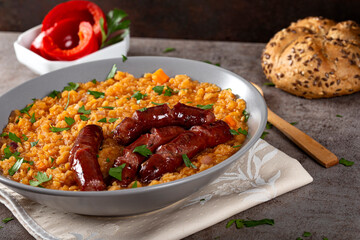 Lentils stew with fried pork sausages