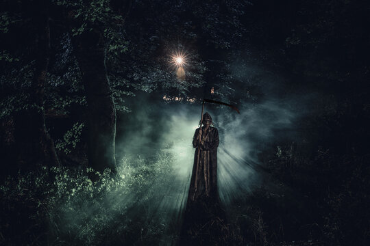Death with a scythe in the dark misty forest. Woman horror ghost holding reaper in forest