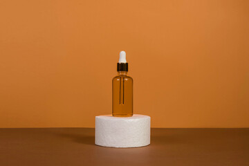 Unbranded bottles in mockup style. Tube of eye oil on a white podium on a beige background. Beauty background with facial cosmetic products. Spa, beauty concept.