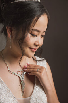 Portrait of a bride with Asian roots on a dark background