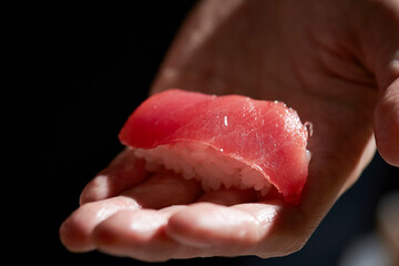 fresh tuna sushi in hand