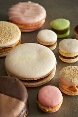 Different types of macarons on a gray background