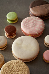 Different types of macarons on a gray background