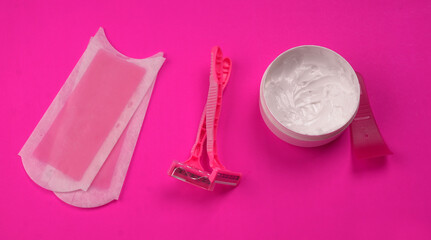 Set of different means for epilation on a colored background. Removal of unwanted hair. Modern epilator, wax strips, razor.