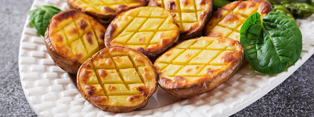 Halves of baked potatoes and asparagus. Dietary menu. Healthy food. Vegan cuisine.