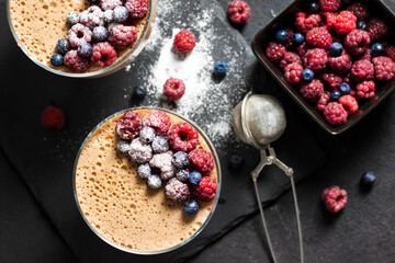 Ryazhenka mousse in glass bowls decorated with fresh berries