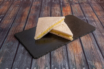 Cream of chicken curry sandwich on white crustless sliced bread