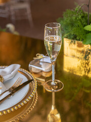 Close-up of a glass of elite champagne on a beautifully decorated festive table in a luxury restaurant.