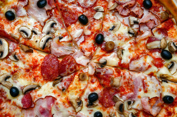 Appetizing pizza with shred, mushrooms, salami, cheese, olives - 448386335