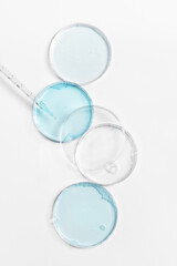 Abstract petri dishes with cosmetic on white background top view. Science cosmetic laboratory...