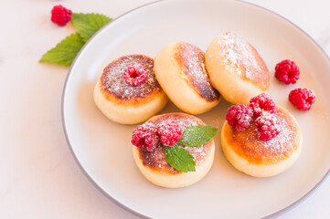 Cottage cheese pancakes, syrniki, curd fritters with berries. Healthy breakfast