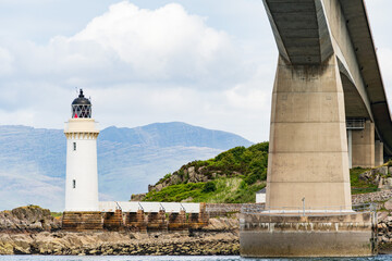 A view of the Skye Road Bridge main span and the Kyleakin Lighthouse.  The lighthouse is on the small island of Eilean Ban. - 448389523