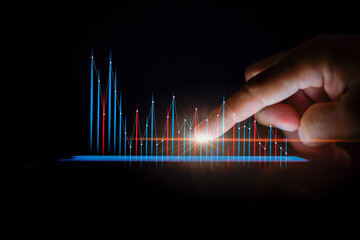 Male hands touching smartphone screen and stock graph