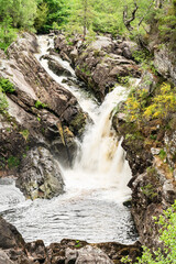 The Rogie Falls, a series of waterfalls near the village of Contin, Ross-Shire, Scotland, UK, viewed here from the suspension bridge. - 448389596