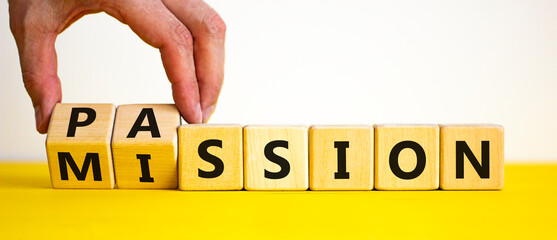 Do your mission with passion. Businessman turns wooden cubes and changes the word 'mission' to 'passion'. Beautiful yellow table, white background, copy space. Business, motivational concept. - obrazy, fototapety, plakaty
