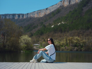 Young woman enjoying beauty of nature of mountain lake.