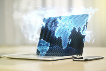 Multi exposure of abstract creative digital world map on modern laptop background, tourism and traveling concept