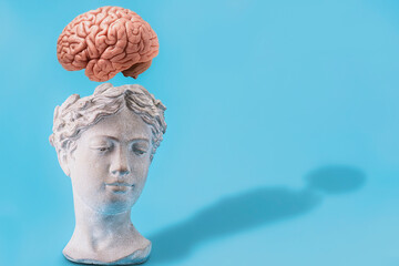 Flying brain from the head of a human statue, creativity and science concept.
