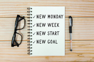 New Monday, New week, new start, new goal text on notebook