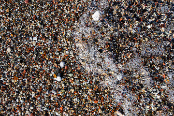 Stones on the beach in sand and water