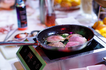 oysters in a frying pan cooks the chef, fire