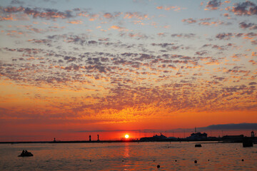 Beautiful sea sunset in the seaport of Sochi. Unusual clouds