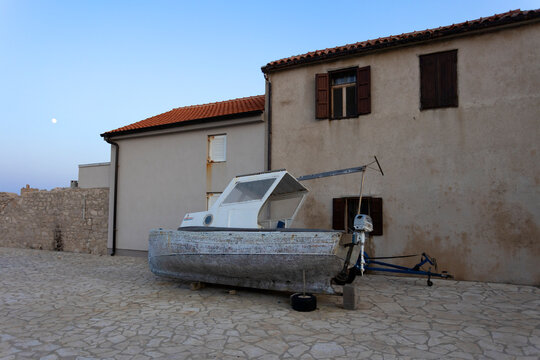 Boat on the ground and house in the village