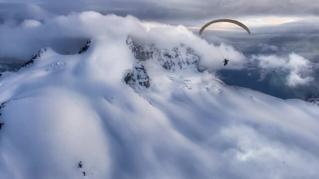 Aerial Panoramic View of Canadian Mountain Landscape with Paraglider flying. Located in Garibaldi near Whistler and Squamish, North of Vancouver, British Columbia, Canada. Parallax Panorama