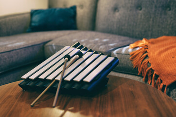 Xylophone resting on wooden table in den