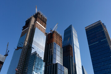 Obraz premium Tall Modern Glass Skyscrapers with Construction at Hudson Yards in New York City