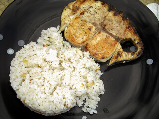Fish steak with rice on a plate 19.1.2015