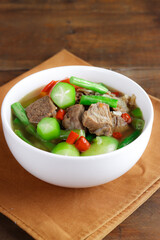 Asem-asem daging sapi or beef soup with sweet and sour taste, a typical dish of East Java, Indonesia.  