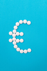 Global Pharmaceutical Industry and Medicine Business - Euro Symbol Made from White Pills Lying on Blue Background