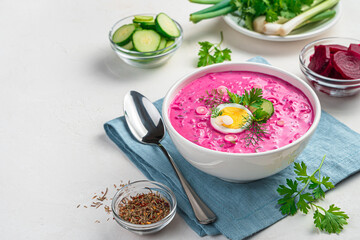 Beetroot soup with dill, parsley and egg on a gray background. Summer, healthy, vegetarian soup.