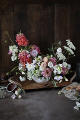 Floral arrangement of summer garden flowers in pastel shades on the table. English floristry. Still life.