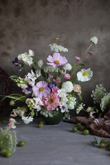 Floral arrangement of summer garden flowers in pastel shades on the table. English floristry. Still life.