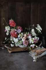 Fototapeta premium Floral arrangement of summer garden flowers in pastel shades on the table. English floristry. Still life.