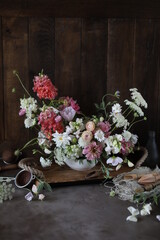 Floral arrangement of summer garden flowers in pastel shades on the table. English floristry. Still life.