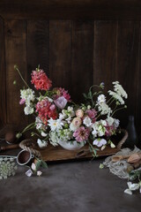 Fototapeta na wymiar Floral arrangement of summer garden flowers in pastel shades on the table. English floristry. Still life.