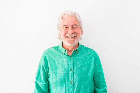 Portrait Of One Old And Mature Man Looking At The Camera Smiling And Laughing - Happy Senior With White Background